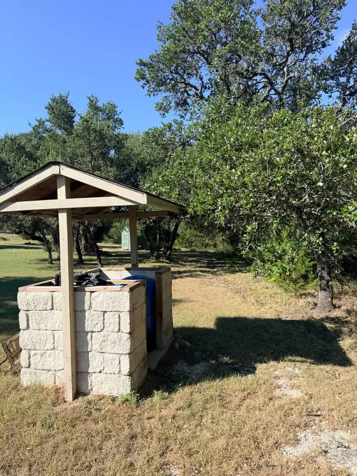 Oak canopy over a stone well house